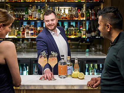 A bartender serving cocktails at RACV City Club's Wine Bar.