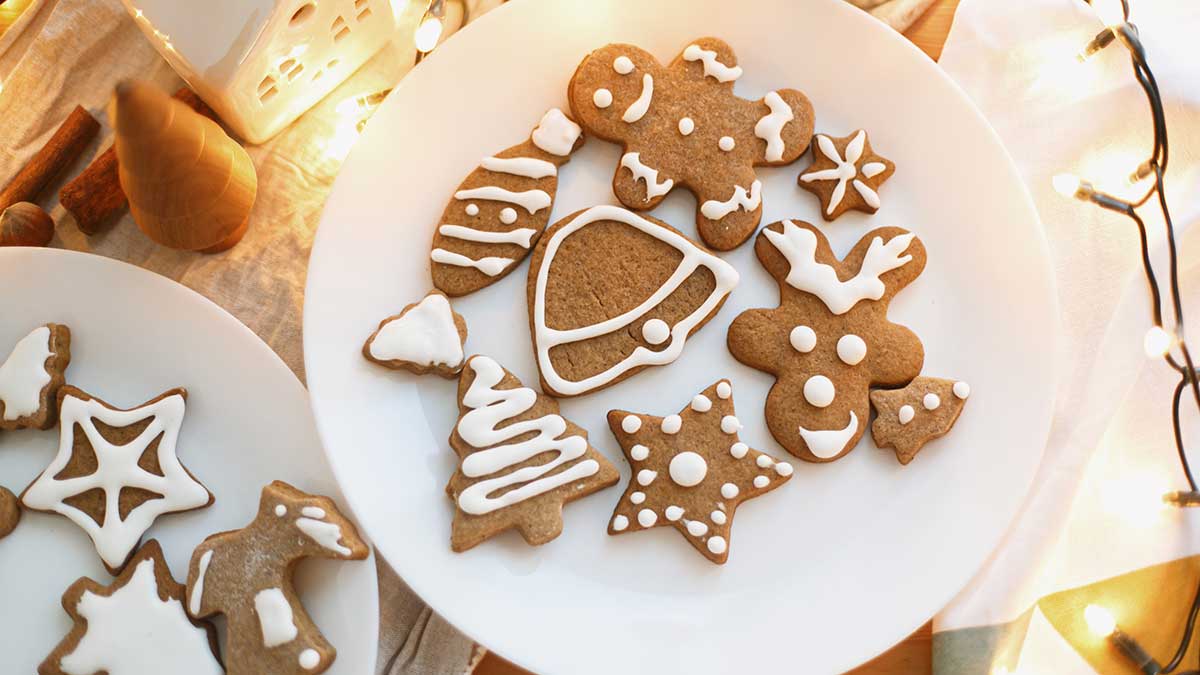 Plate of gingerbread biscuits shaped like trees, bells, raindeer and stars for Christmas